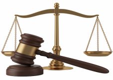 Gavel and scales isolated on white