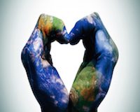 a world map in man hands forming a heart (Earth map furnished by NASA)