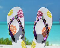 Two pairs of flip-flops against Atlantic. Exuma, Bahamas